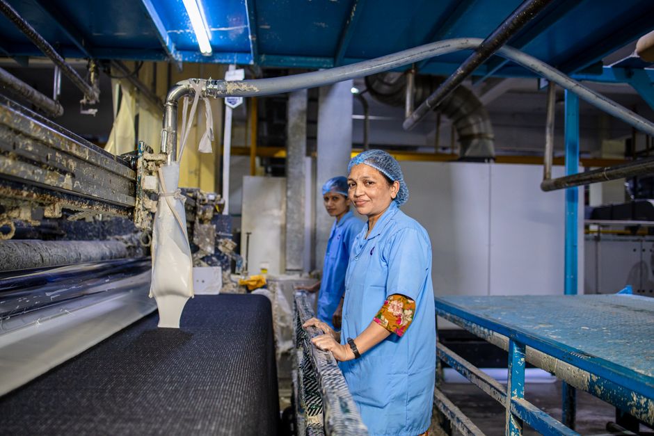 Workers managing production machines indoors