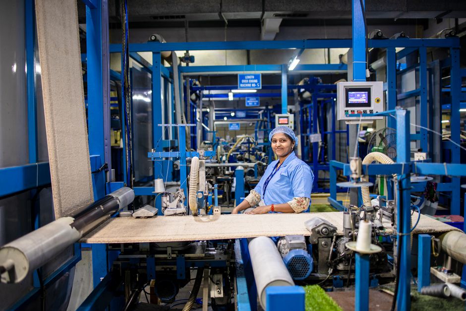 Indian factory worker operating precision machinery