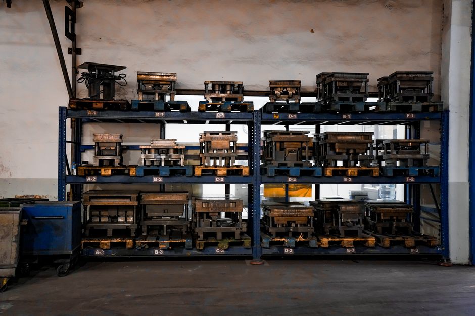 Metal molds arranged on industrial shelving