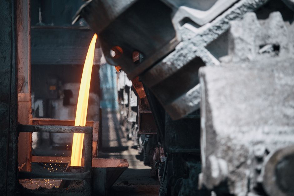 Molten metal pouring from a ladle in a foundry